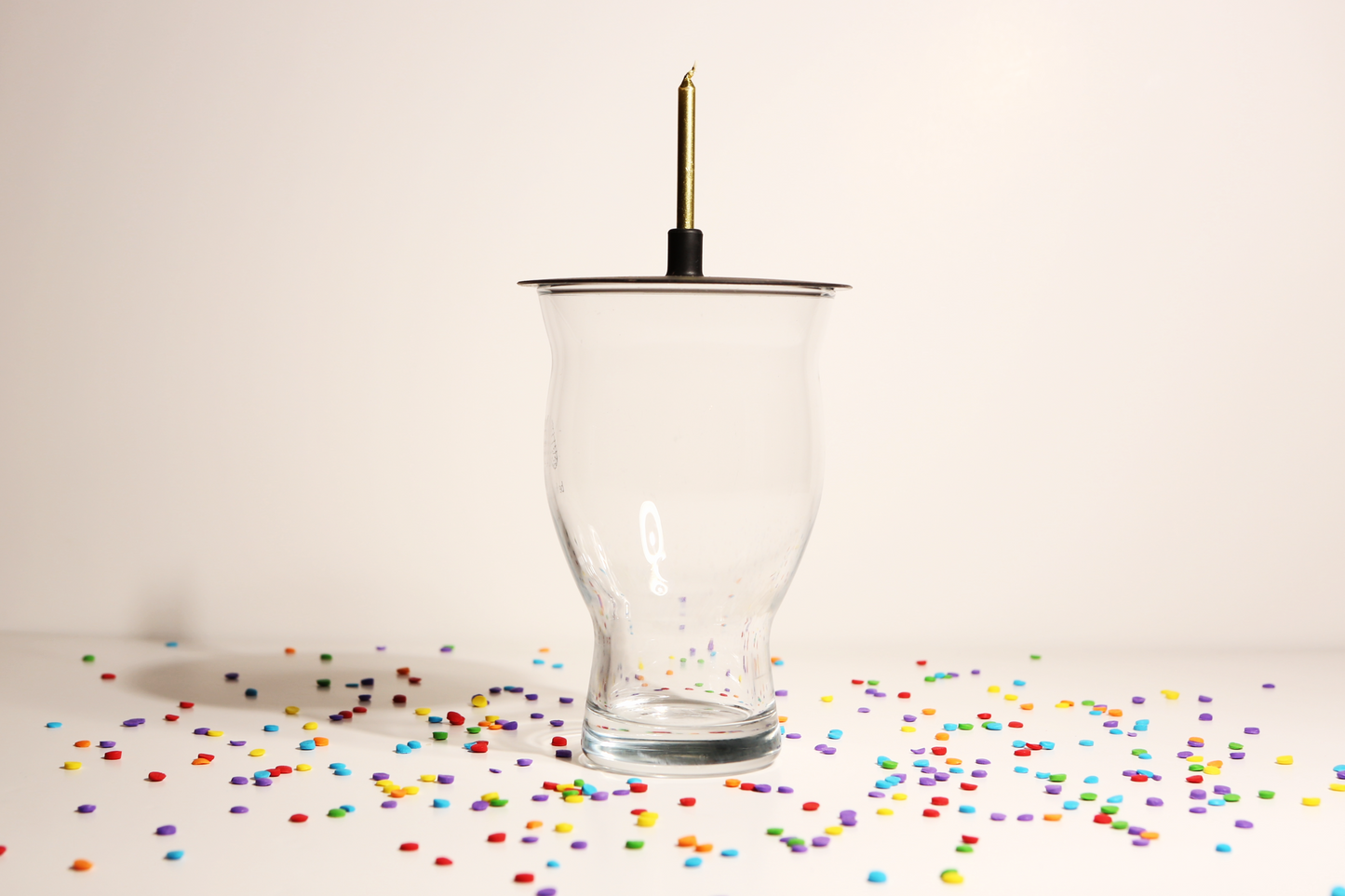 Lit Lids silicone candle holder on a glass
