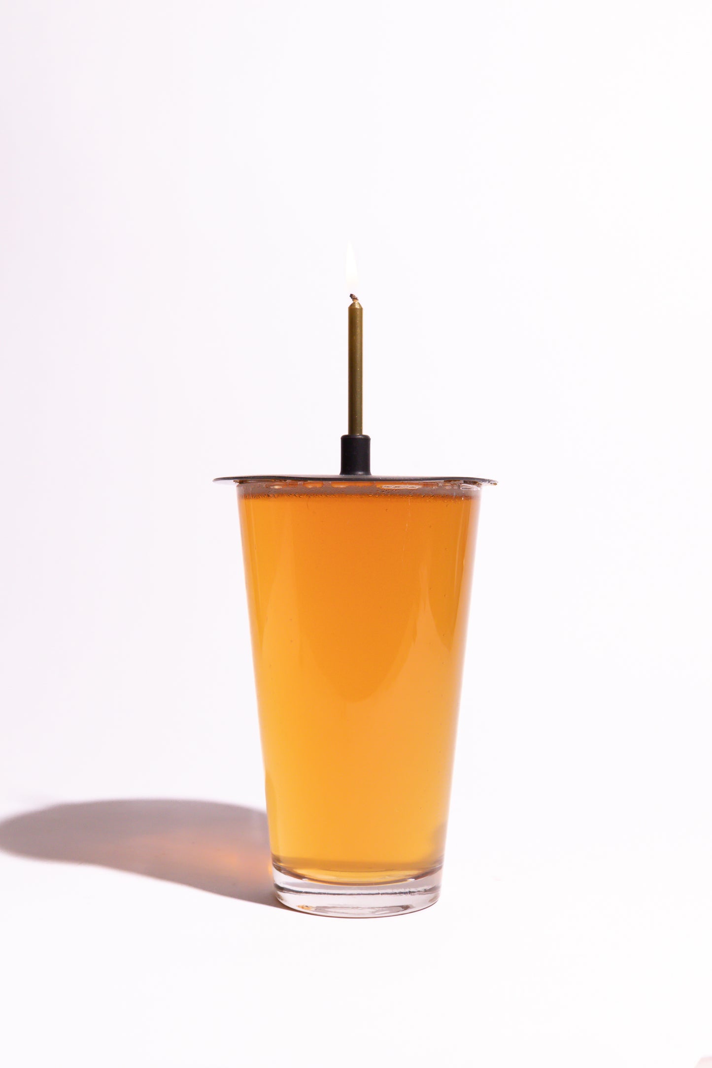 Lit Lid on pint of beer on white background