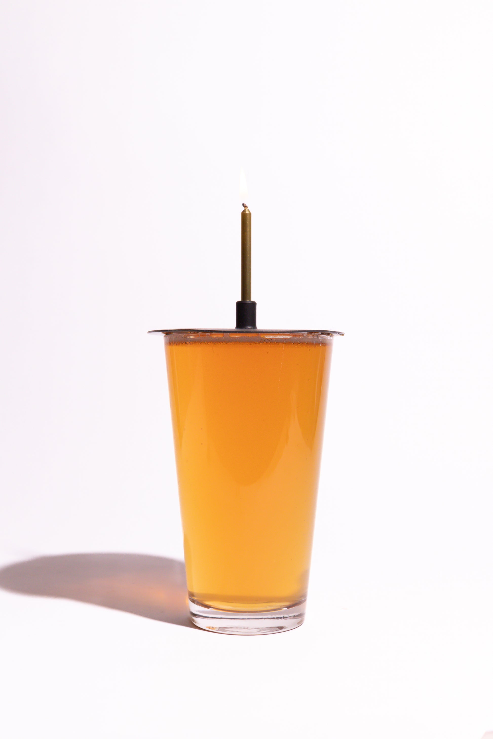 Lit Lid on pint of beer on white background
